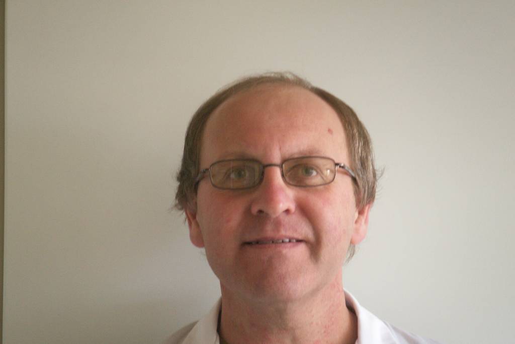 Headshot of Jacques Botte in a lab coat at work.