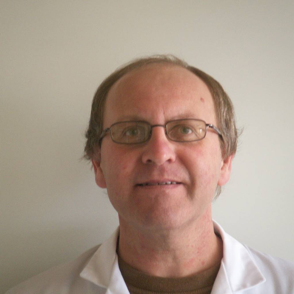 Headshot of Jacques Botte in a lab coat at work.