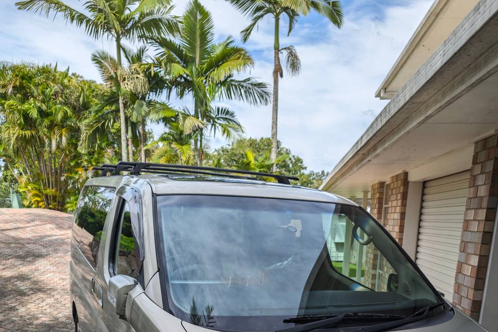 The Nissan Elgrand parked in a tropical driveway, 2024.