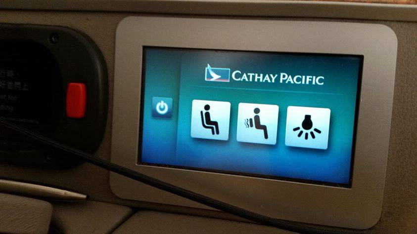 A Cathay Pacific seatback touchscreen photographed during a flight.