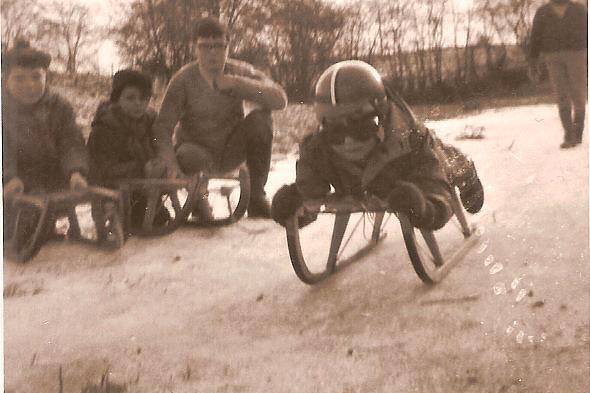 Jacques in the snow with his red helmet and his favourite red toy car, winter 1968.