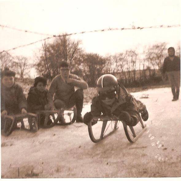 Jacques in the snow with his red helmet and his favourite red toy car, winter 1968.