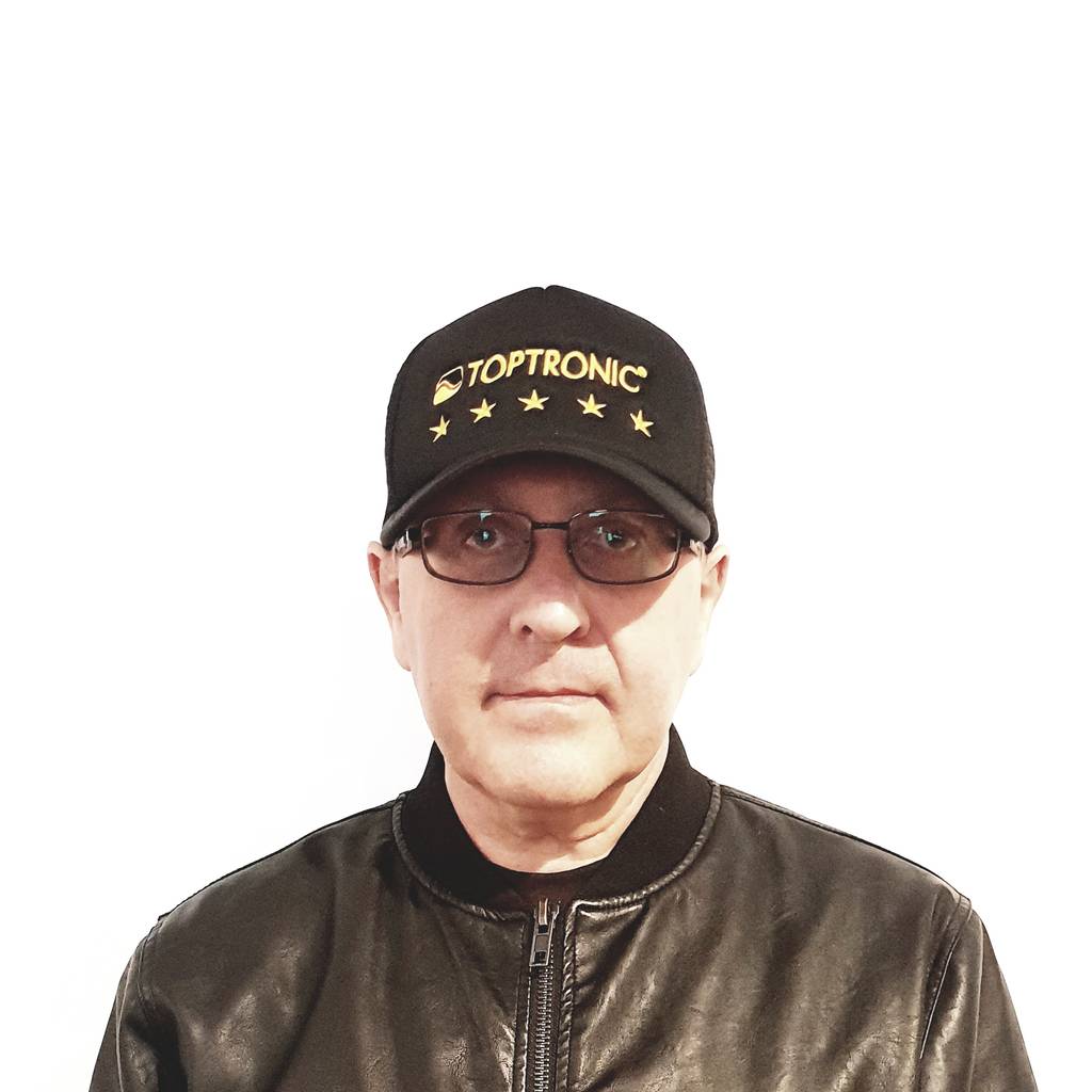Portrait of Jacques Botte wearing the Toptronic® five-stars cap and jacket against a white background.
