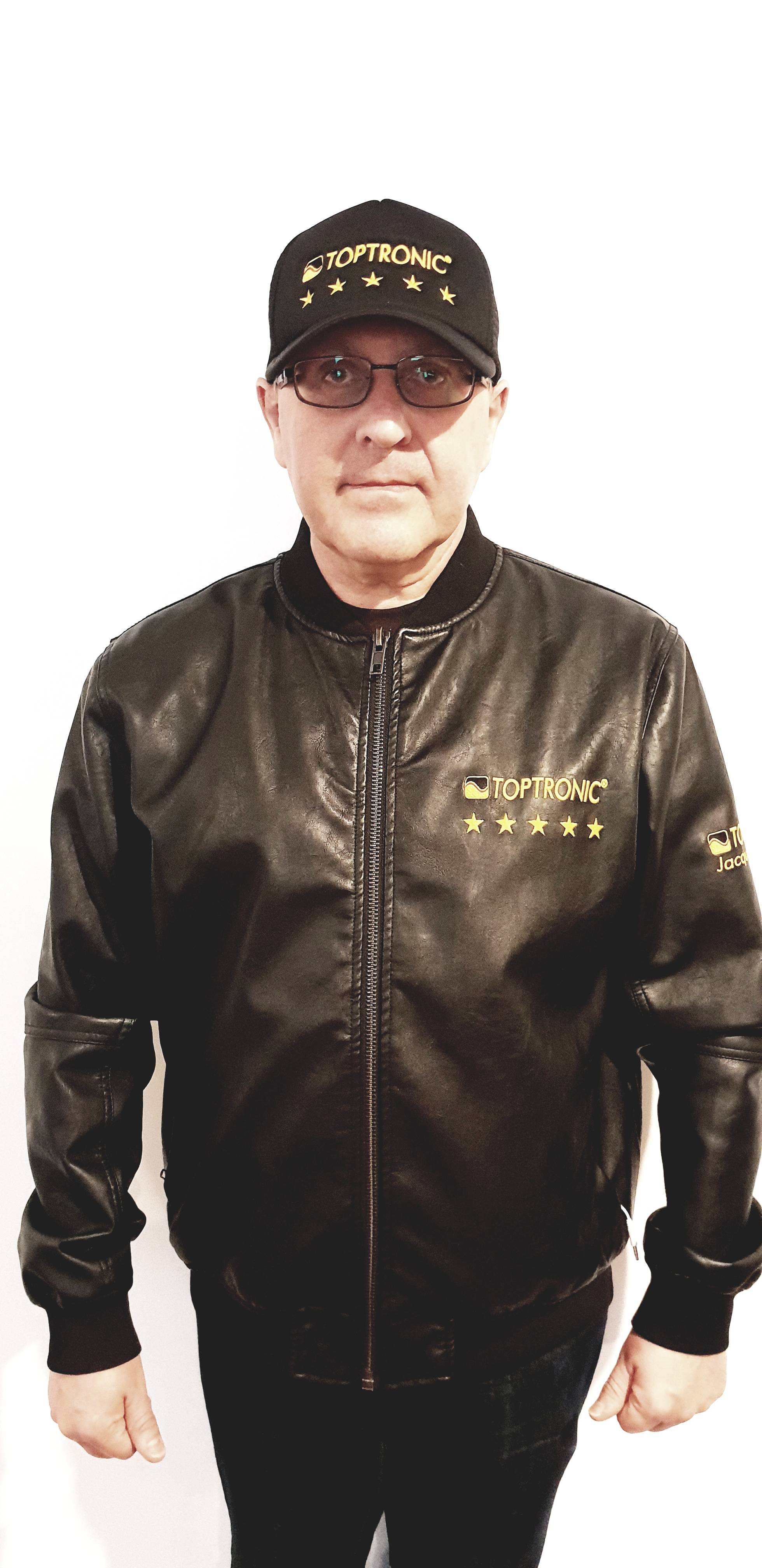 Portrait of Jacques Botte wearing the Toptronic® five-stars cap and jacket against a white background.