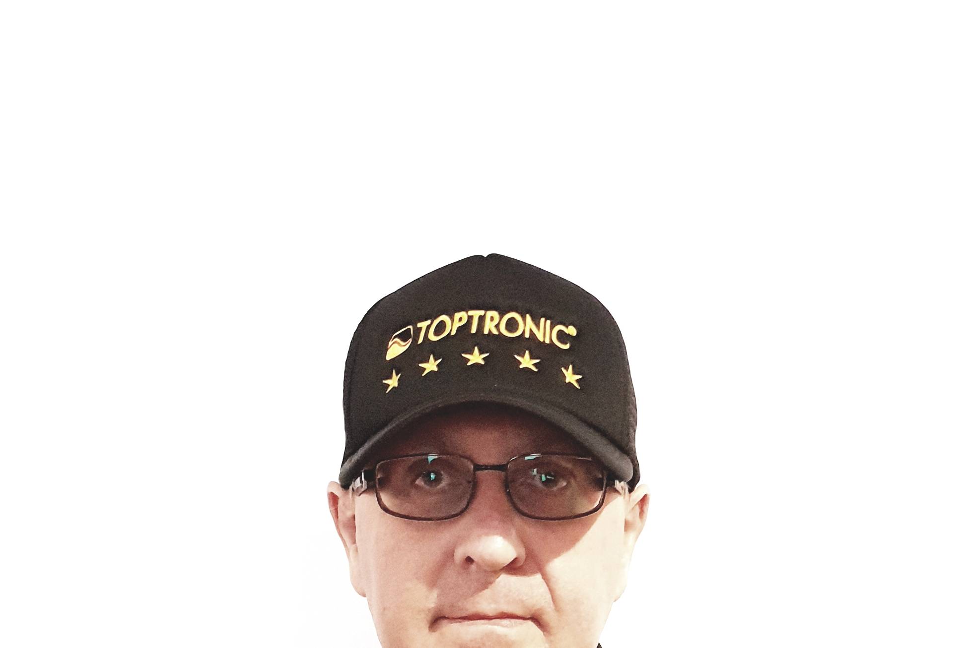 Portrait of Jacques Botte wearing the Toptronic® five-stars cap and jacket against a white background.